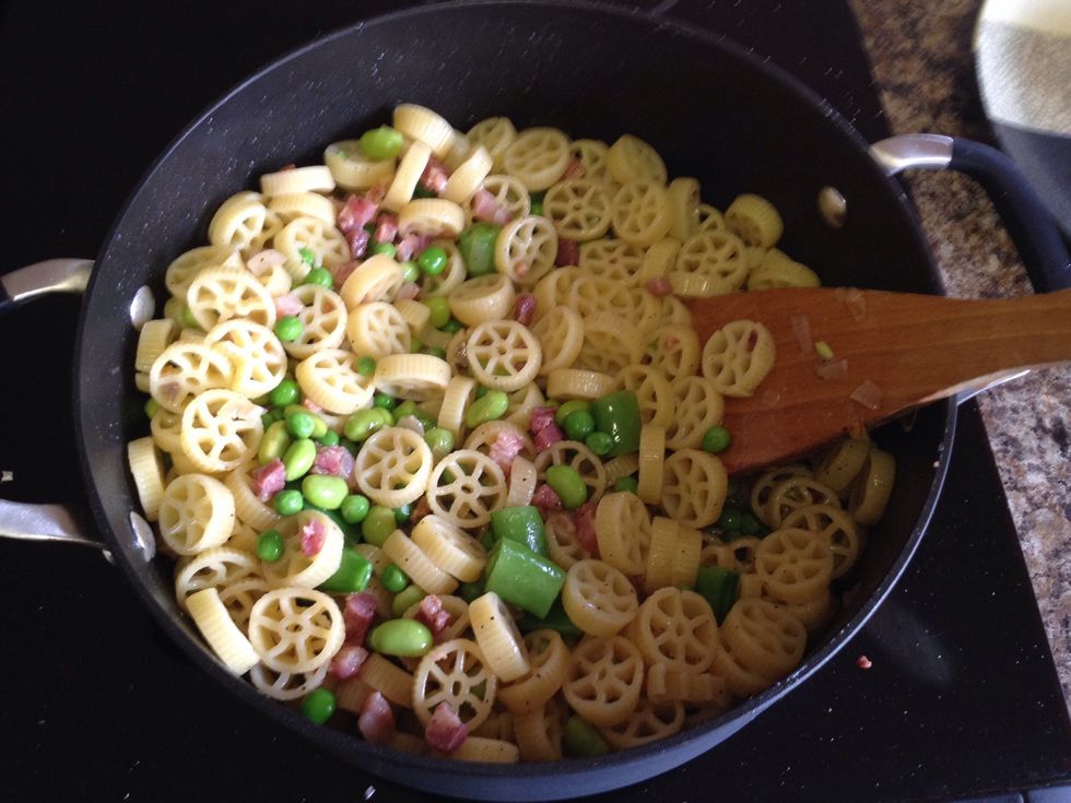 Add pasta, peas, edamame, cooked pancetta, salt, and pepper.