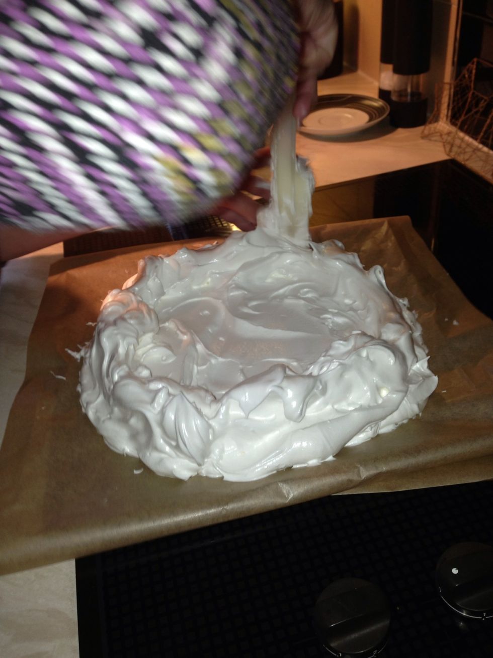 Add peaks to the edge of the circle and bake in the oven for 1 and 1/2 to 2 hours. Turn oven off and leave in the oven overnight or as long as possible. This stops cracking.