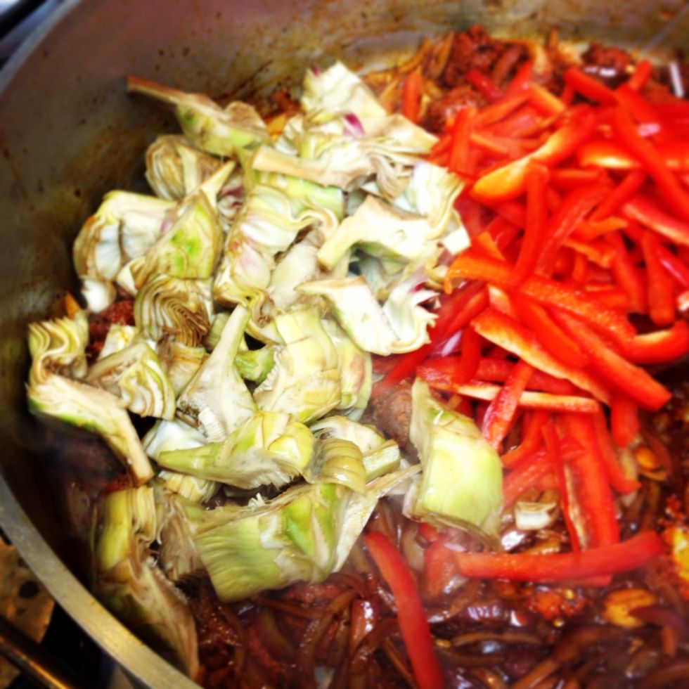 Add peppers and artichokes, sweat