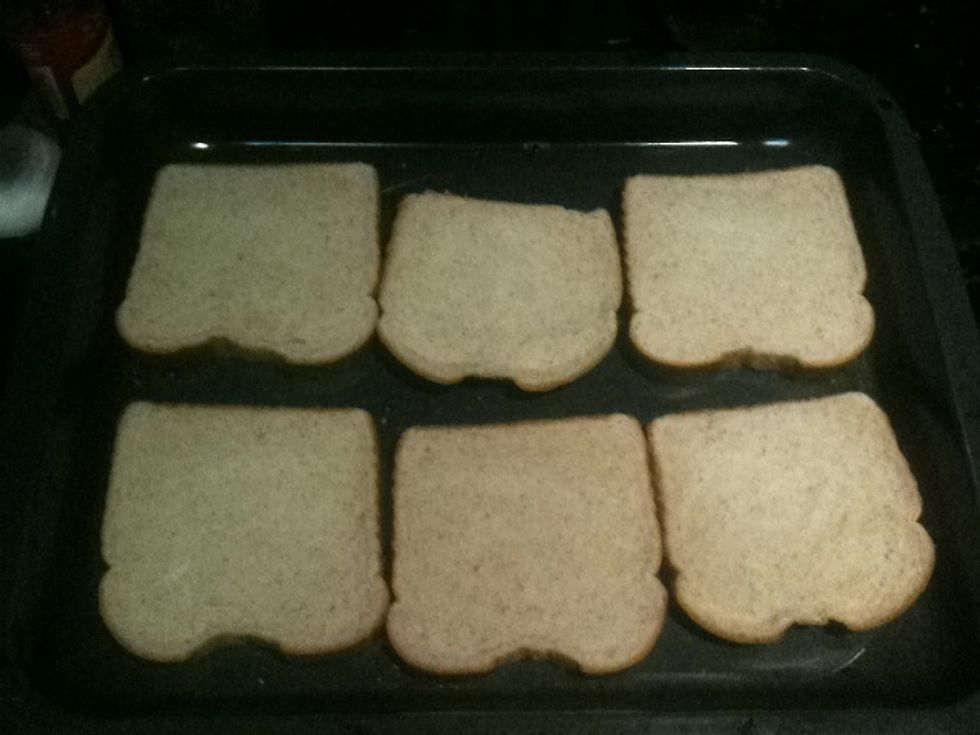 Add pieces of bread to a baking pan.