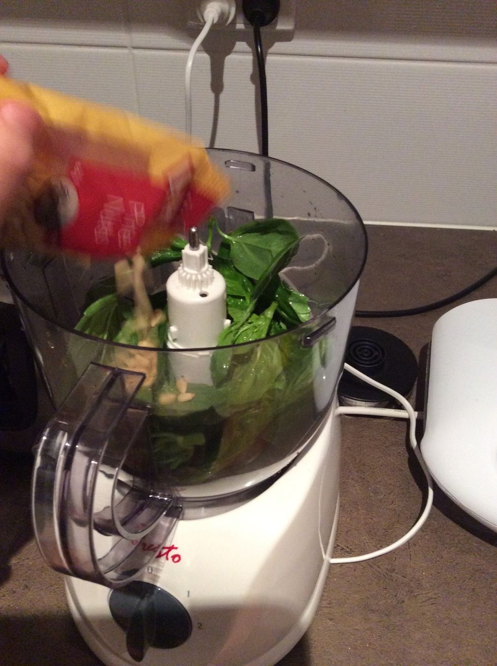 Add pine nuts to basil then blend