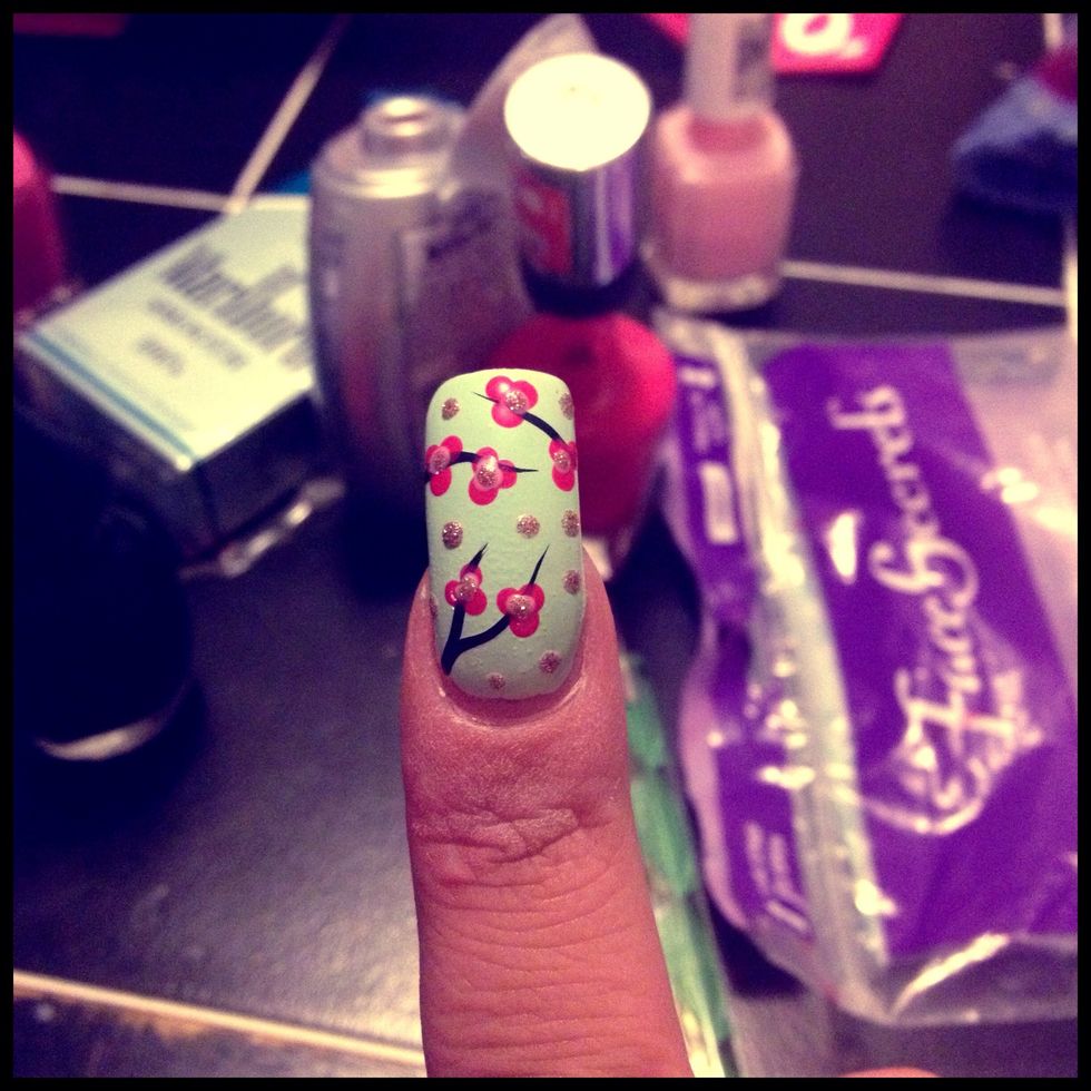 Add pink dots in the middle of the nail and add random glitter dots through out the empty spaces in the nail