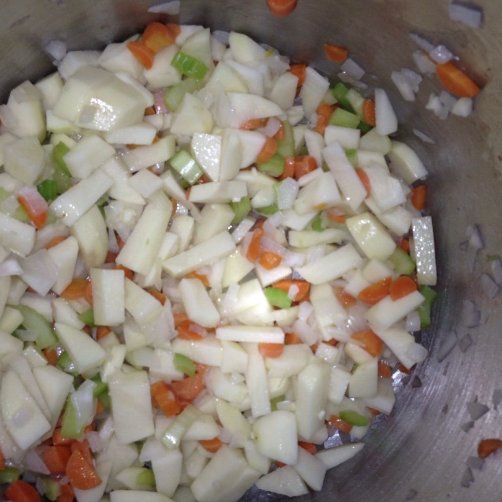 Add potatoes and garlic to pot. Let cook for a couple of minutes.