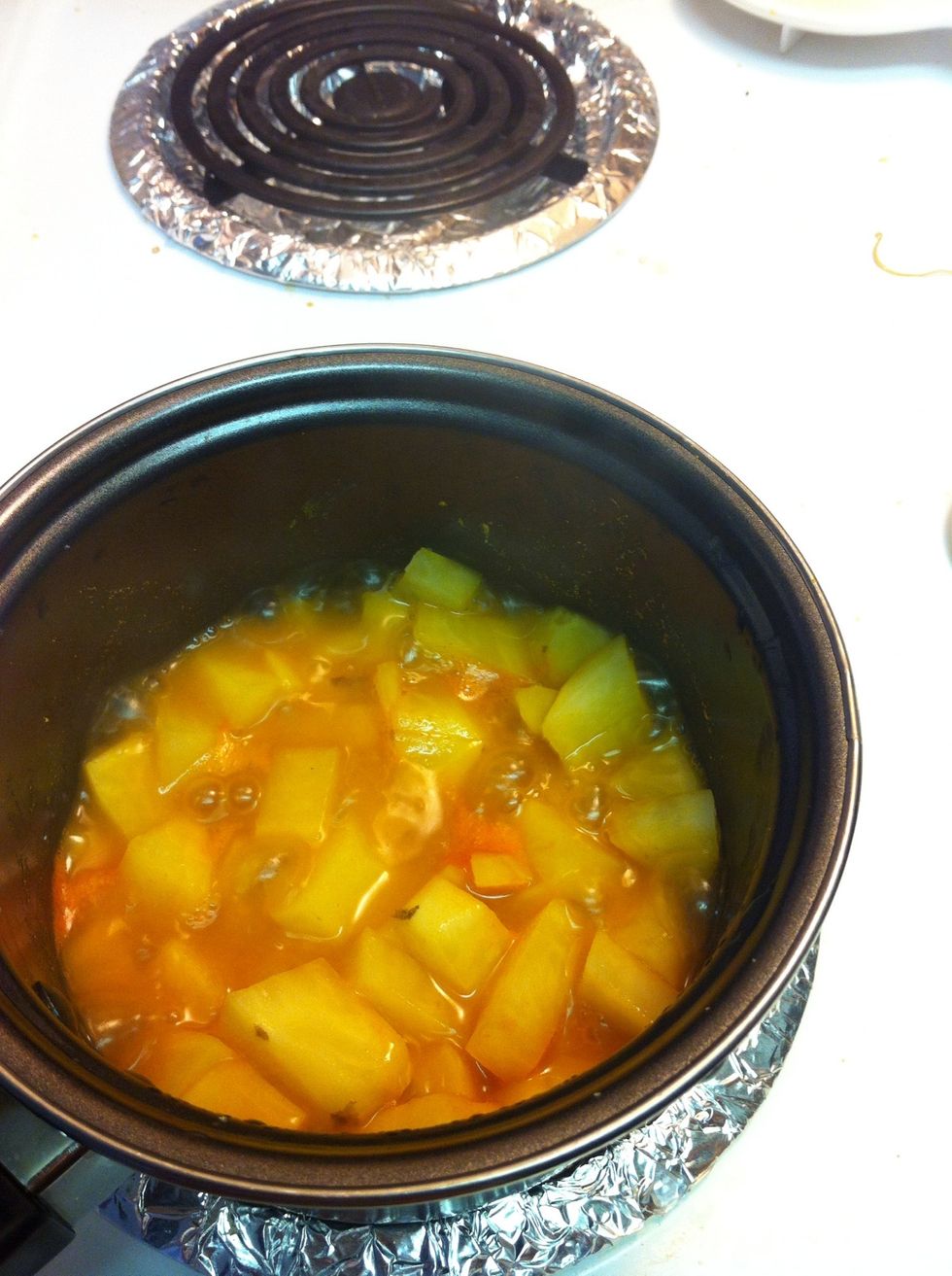 Add potatoes to the pan and add one cup water to boil along with turmeric , salt and chilli powder