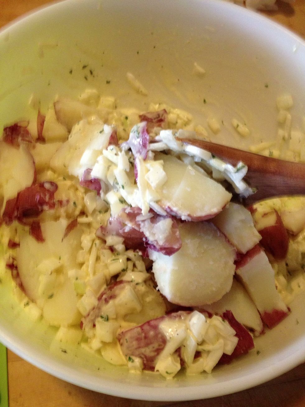 Add potatoes while still quite warm but not boiling hot. This is crucial for the favors to meld. I just add each one after it is cut and then stir.