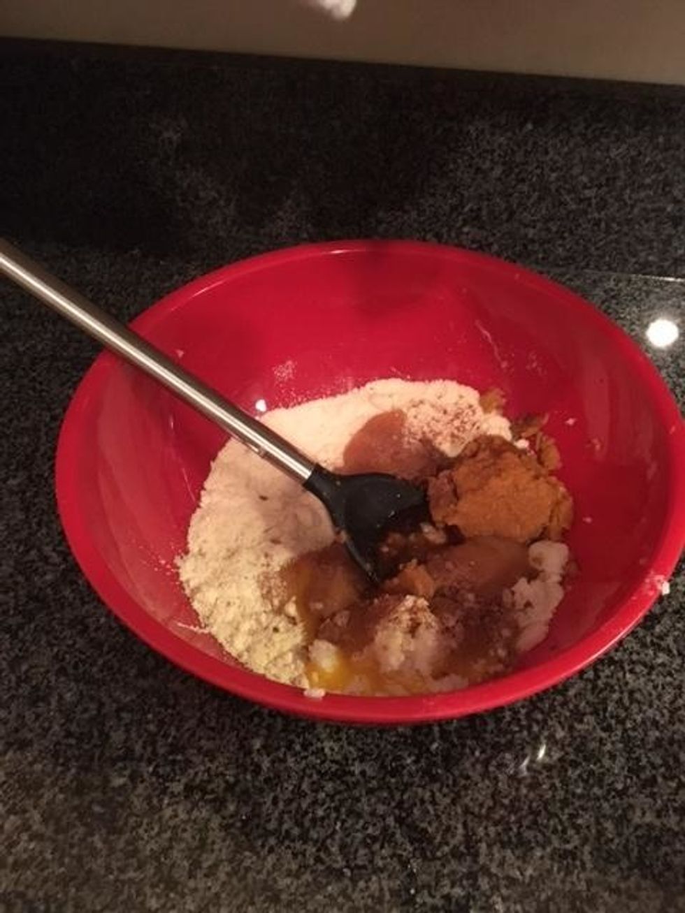 Add pumpkin puree, egg, honey, coconut oil, vanilla, maple flavor, and pumpkin pie spice to bowl