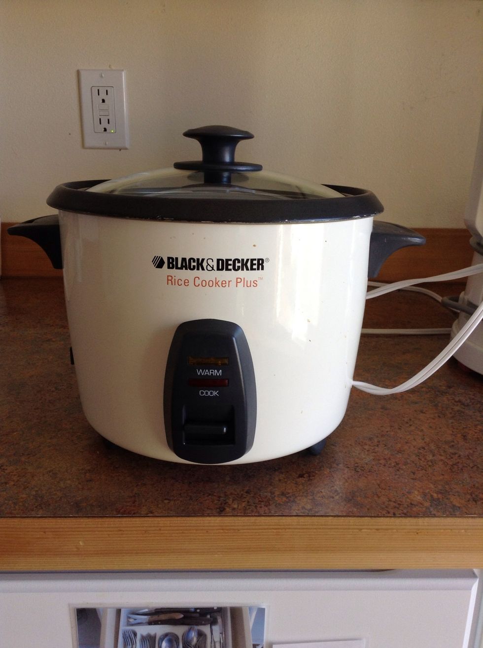 Add quinoa and water to rice cooker. Turn on by pushing the handle down. When handle pops back up quinoa will be done