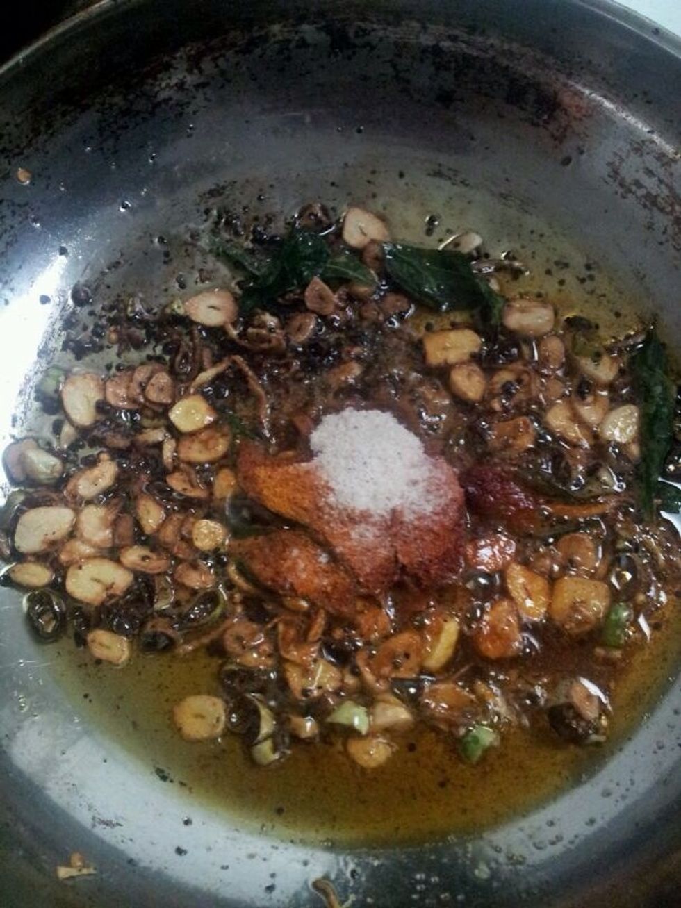 Add red chili powder, turmeric powder, and asafetida. Fry until raw smell of chili powder subsides.