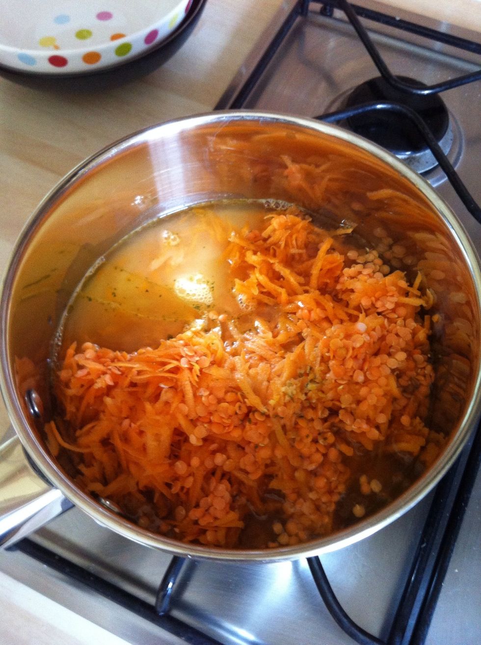 Add remaining ingredients (carrots, lentils, vegetable stock, milk and oil) to the pan.