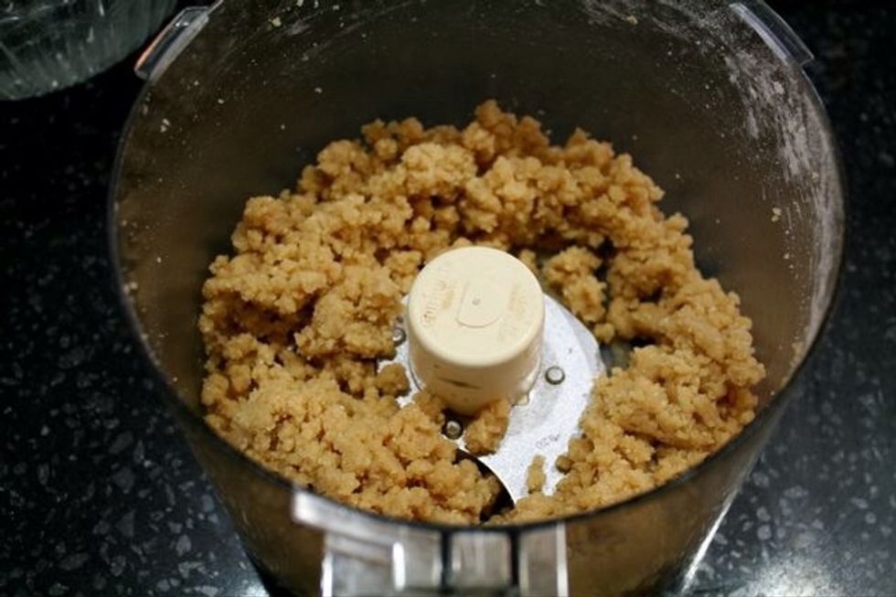 Add remaining ingredients, including the cheese, to the oats in the food processor. Process until well combined, about 2 minutes. The dough should form a ball when pressed together.