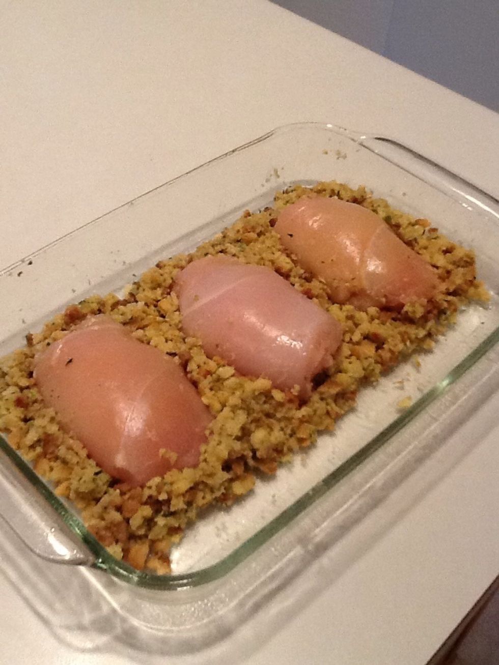 Add remaining stuffing around chicken breasts.