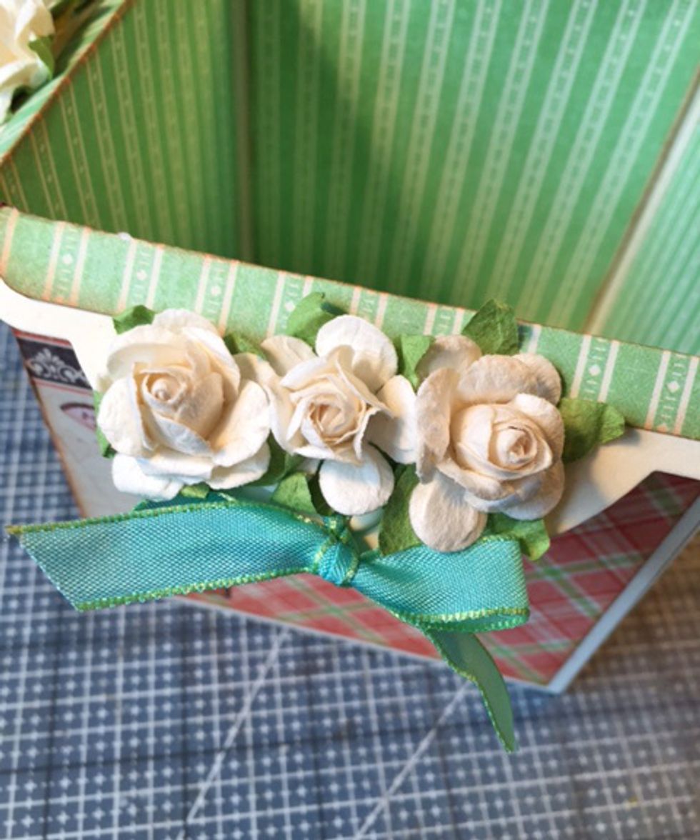 Add ribbon and/or flowers, charms or embellishments you choose to tag holes.