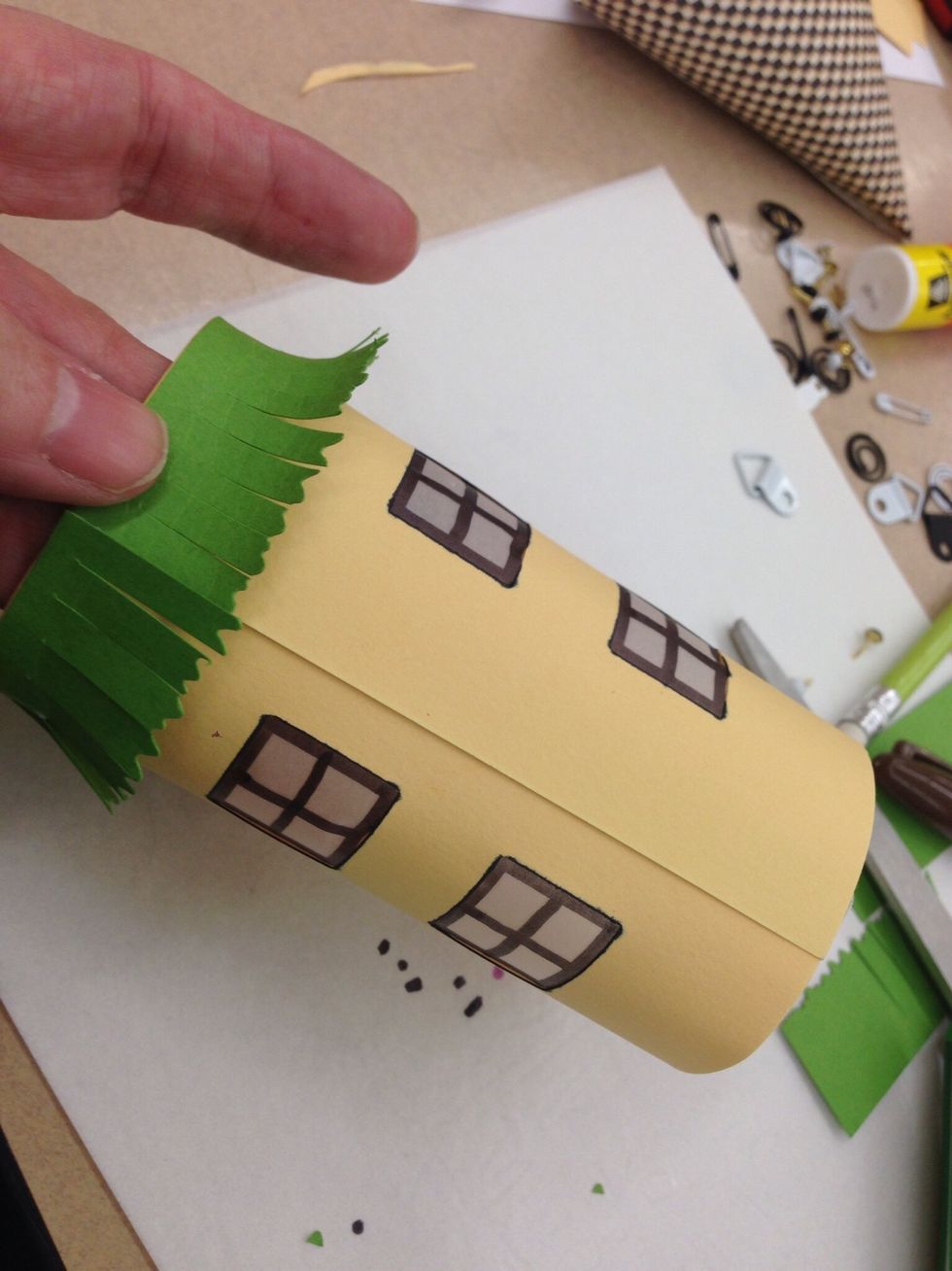 Add ribbon or other trims with tacky glue. This house has grass made from a strip of paper.