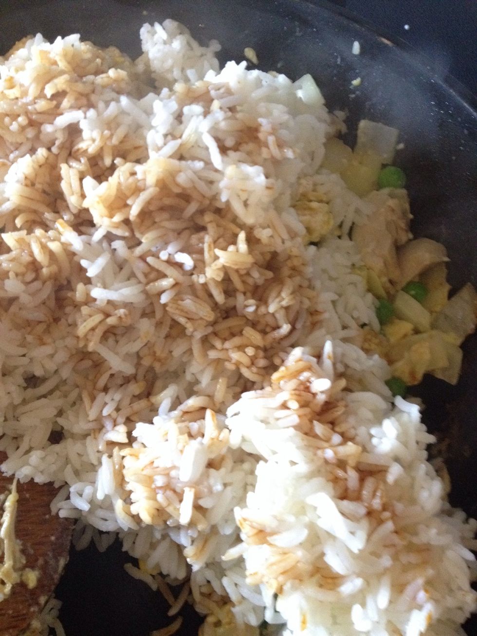 Add rice and 2 table spoon of soy sauce
