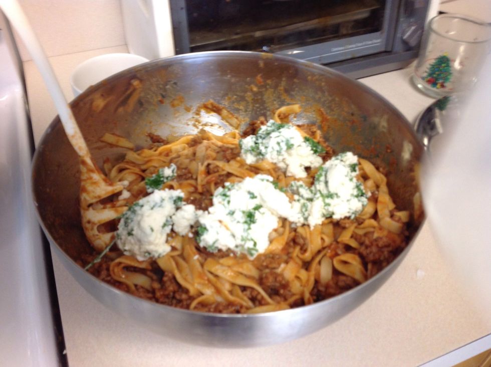 Add ricotta herb topping to pasta and serve.