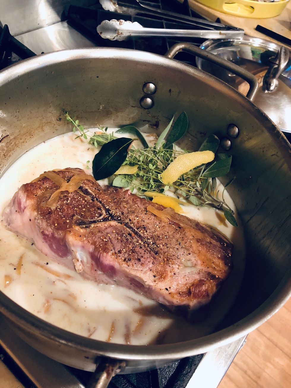 Add sage, thyme, lemon and milk. Bring to a simmer.