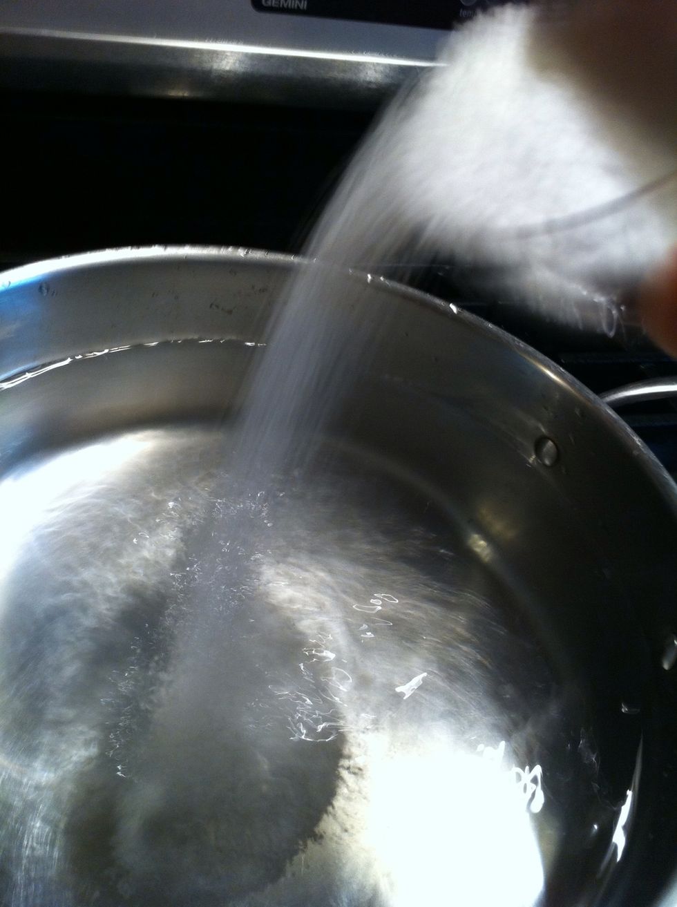 Add salt...and plenty of it. The salt water gives the pasta it's flavor.