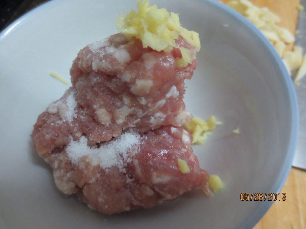 Add salt and the minced ginger into the ground pork
