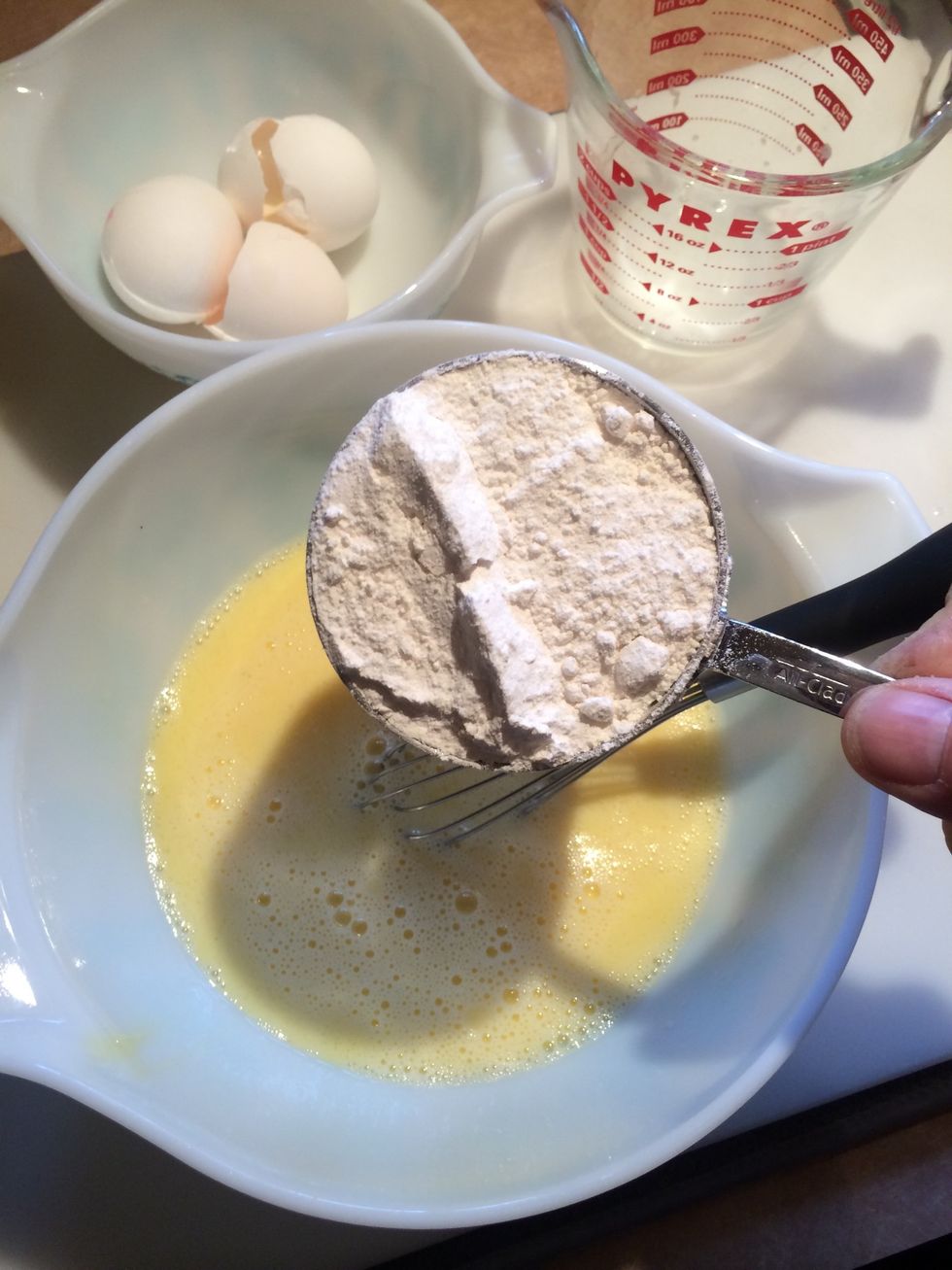 Add salt. Gradually add flour and whisk again.