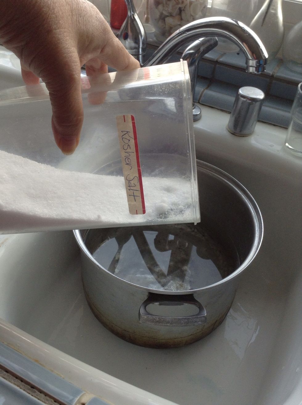 Add salt - I'm using kosher salt because it's coarser which makes it dissolve better in water but less on the surface of the chicken.