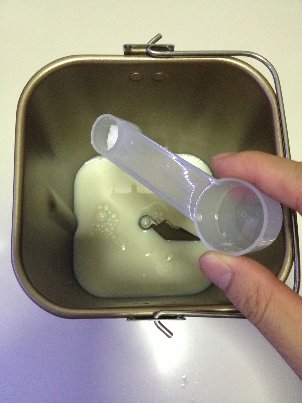 Add salt into one corner of the container.