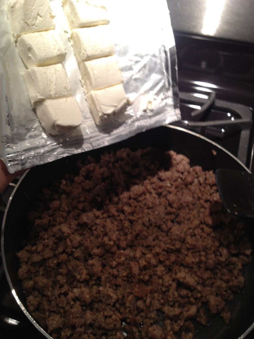 Add sausage and cream cheese back to skillet and put over medium low heat.