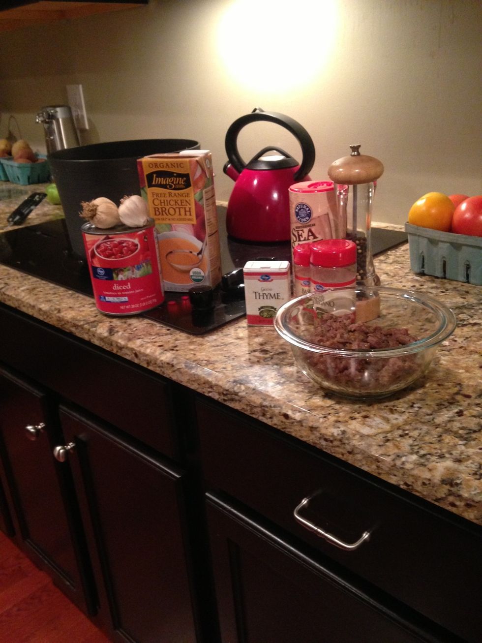 Add sausage back into pot with garlic, broth, tomatoes and spices.