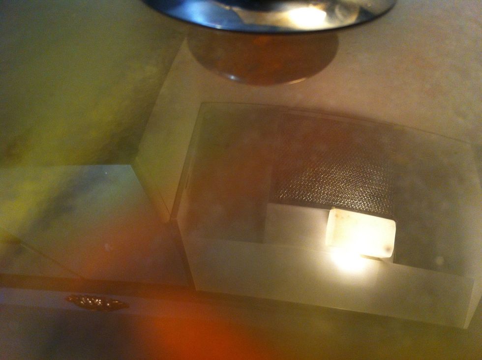 Add scallions and water at high heat, cover and simmer