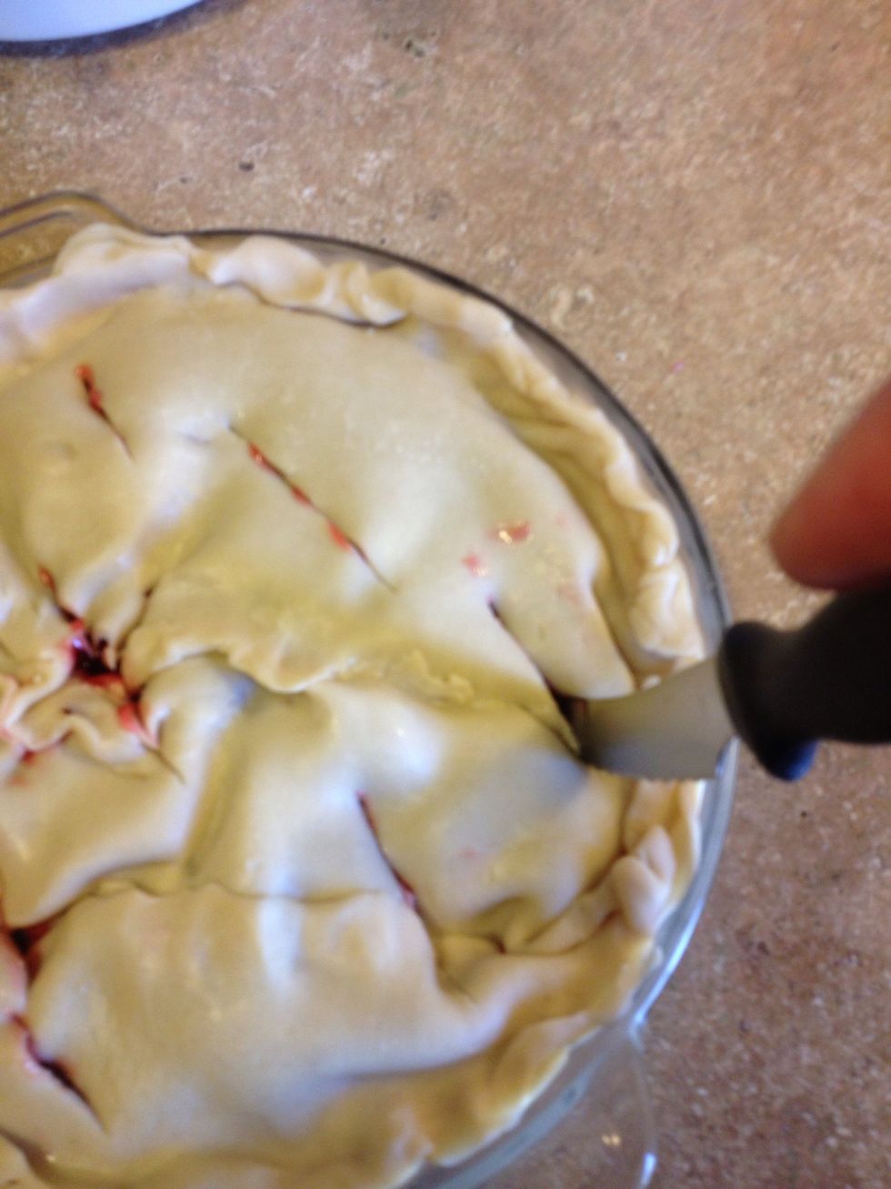 Add second pie crust to top, pinching sides together and cut slits in top
