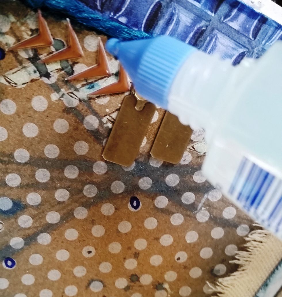 Add sections of Tombow Aqua Mono Liquid Glue around the page for the blue Micro beads to stick to.  Add some  random circles in Reflex Blue Dual Brush Pen using the brush side.