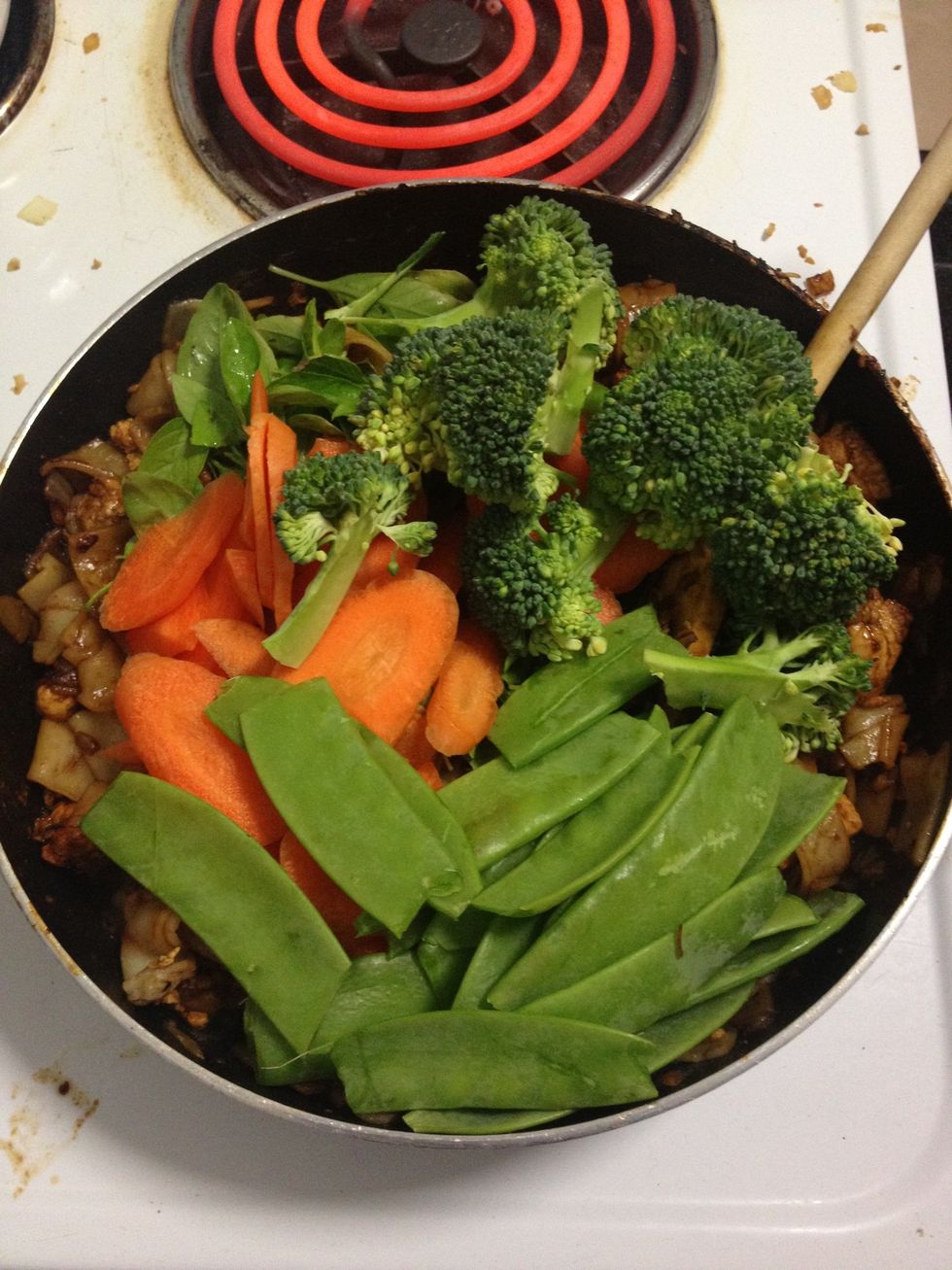 Add selection of vegies and stir. Add water and mix altogether.