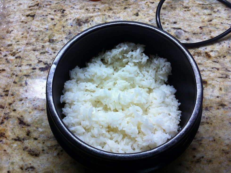 Add sesame oil to coat the bottoms and part of the sides  of each bowl. Press a thin layer of rice to the bottom and side for the crisp factor. Add remaining desired amount of rice to the bowl.