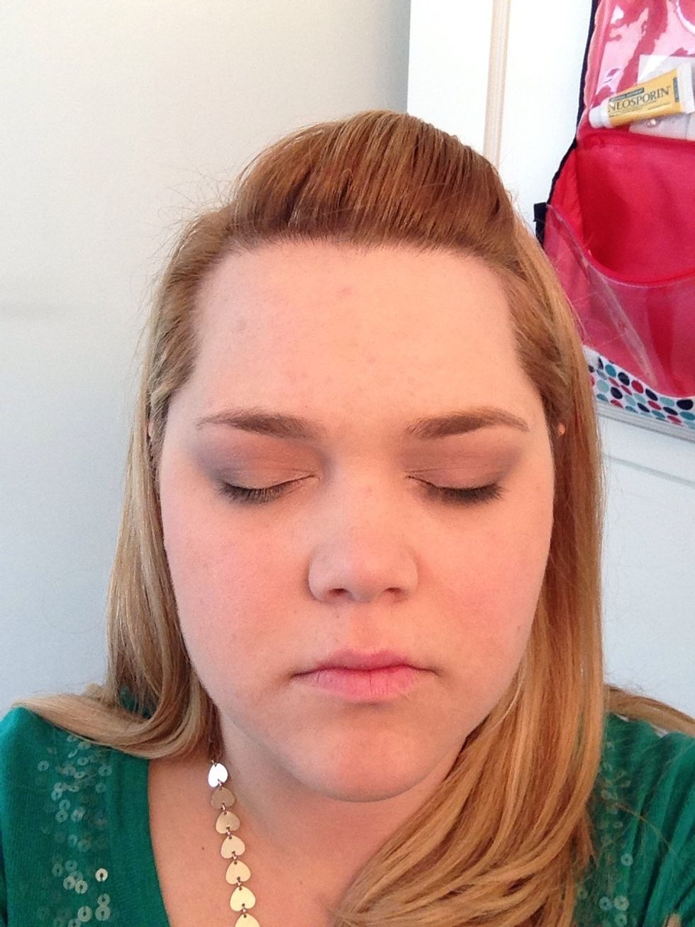 Add shimmery light pink shadow to your lid, from the inside of the eye to about halfway out, stopping in the middle of your pupil as you look straight ahead.