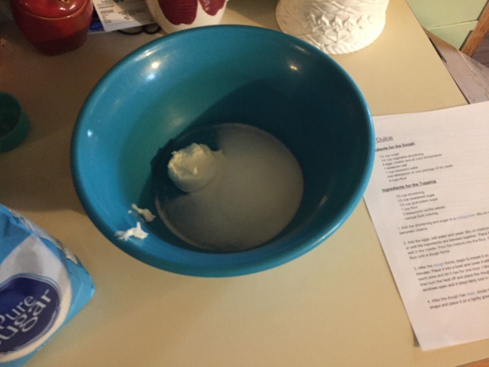 Add shortening and sugar into a mixing bowl