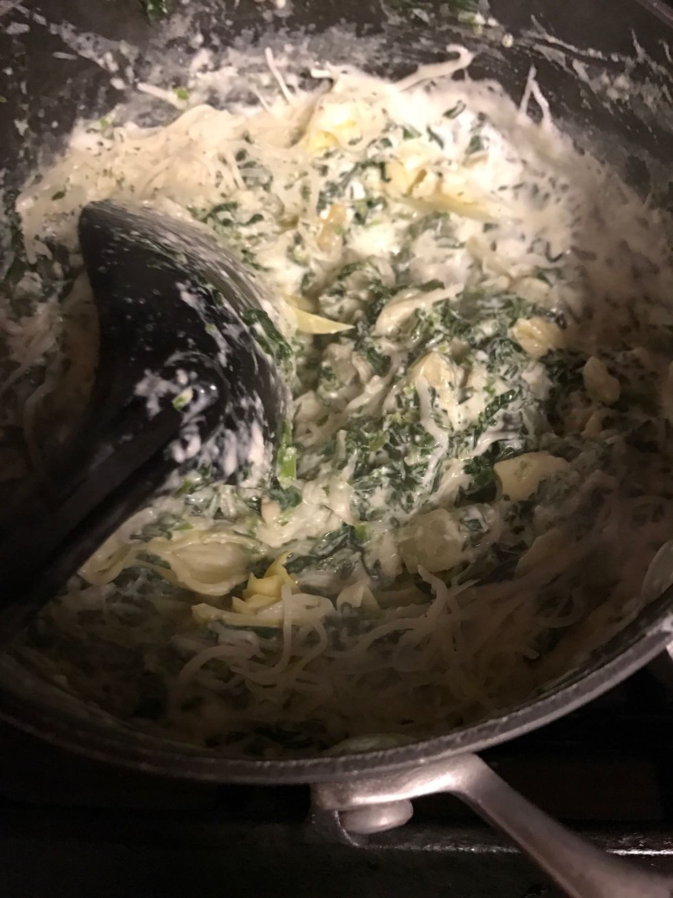 Add shredded cheese and stir until melted but keep 1/2 cup out