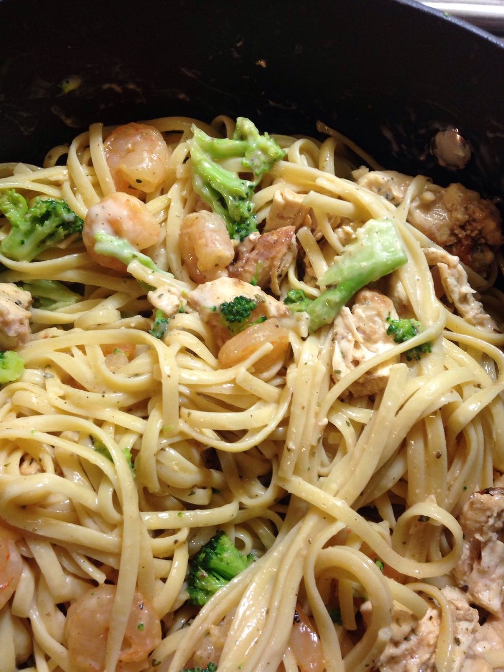 Add shredded chicken and shrimp with steamed broccoli to pasta and mix with Alfredo sauce gradually