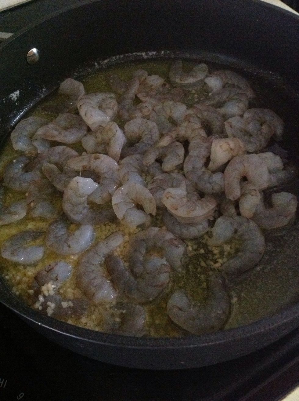 Add shrimp and garlic to large skillet once butter is melted.