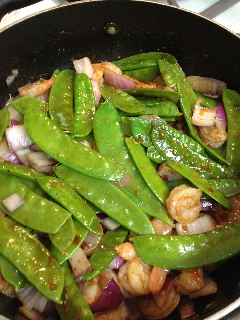 add shrimp, snow peas, and onion to hot saut\u00e9 pan or wok. cook for three minutes before adding the water chestnuts, cashews, and pineapple.