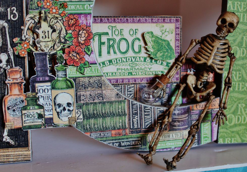 Add skeleton, small jar and journal block to letter "C".