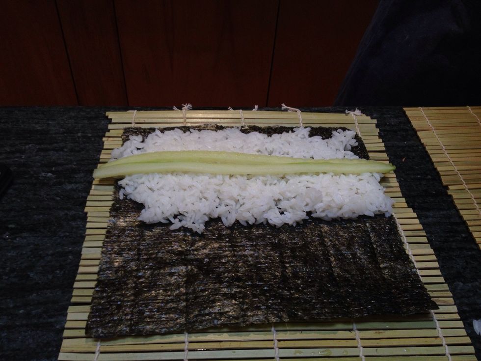 Add sliced cucumbers. I slice these cucumbers lengthwise with the skins removed using a mandolin.