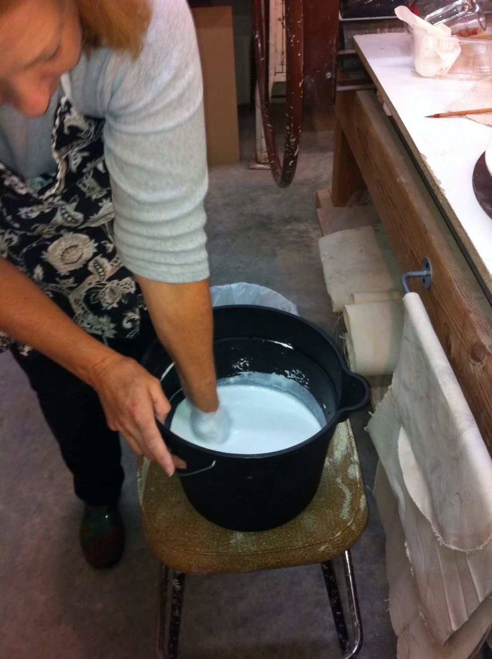 Add slowly to 1 quart of water, let sit for 2-3 minutes then stir slowly by hand breaking up clumps, not too fast you don't want air bubbles.