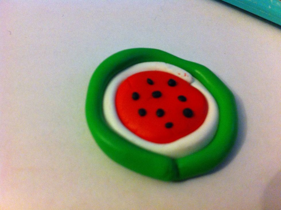 Add small black pieces ontop of the red circle.