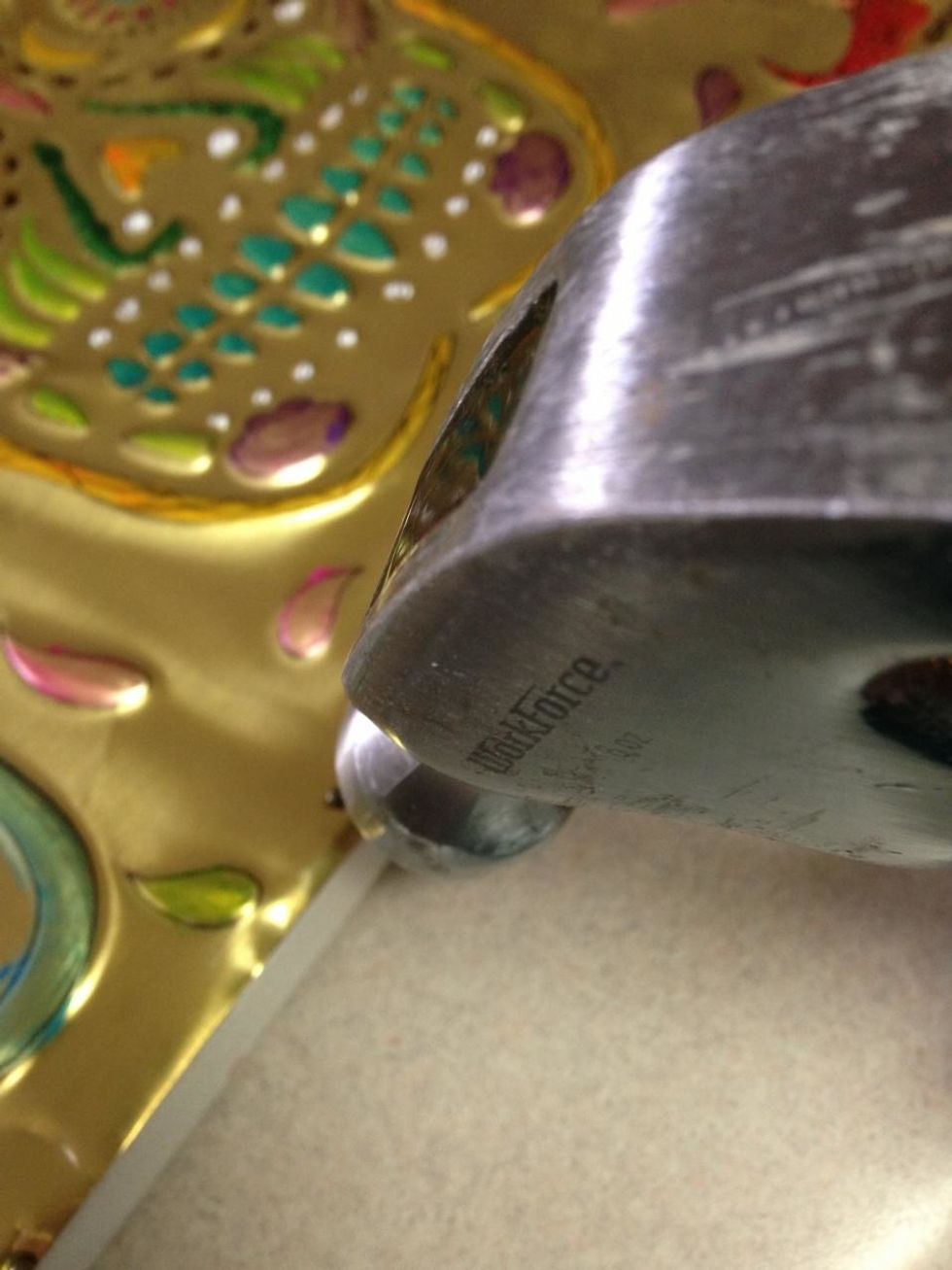 add small brass nails at even intervals around canvase...