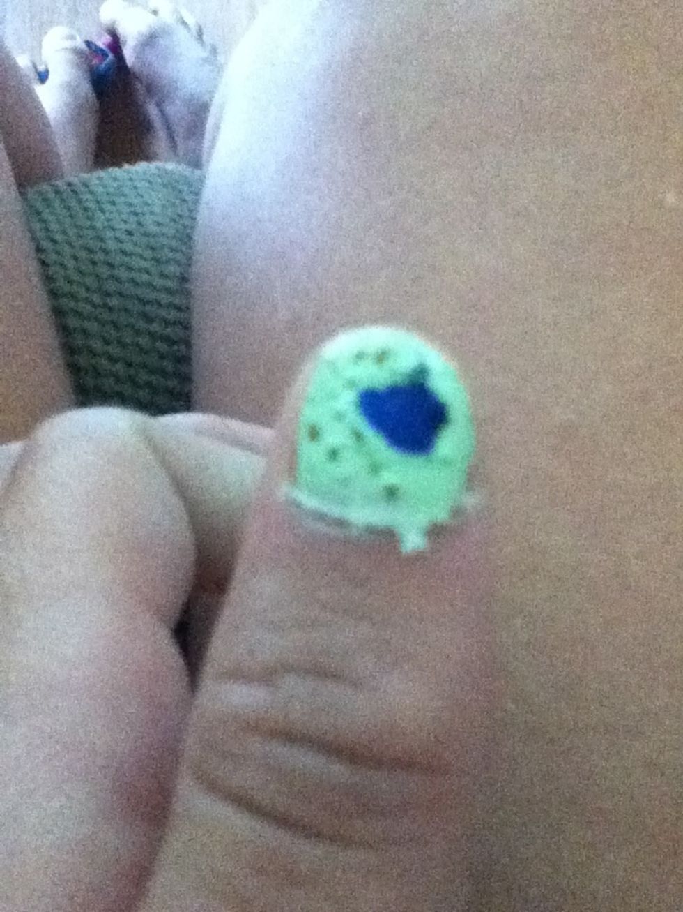 Add small holes in the green nail polish to look like paw prints.