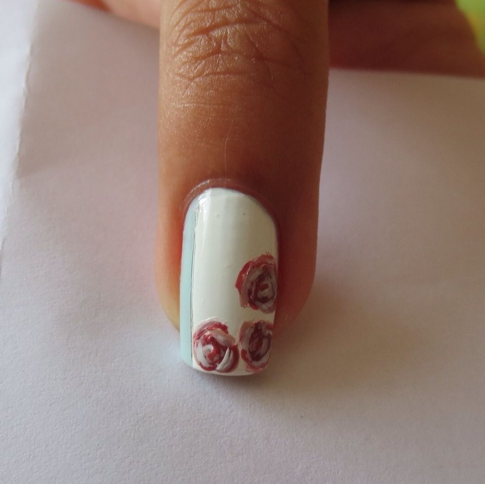 Add small shadows to the rose to make them look more 3D with a thin nail art brush and white polish (or toothpick)