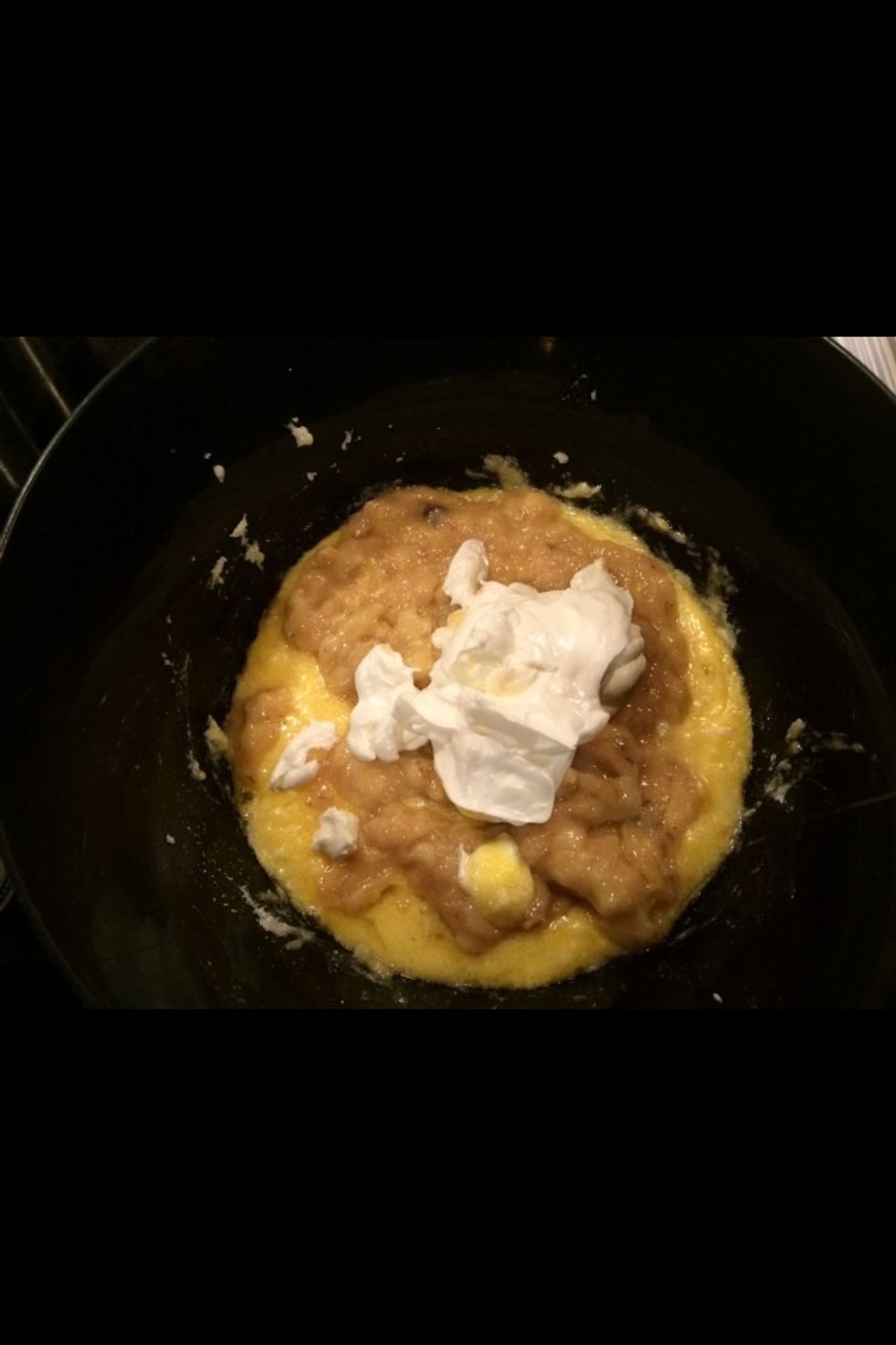 Add smashed bananas and 1/2 cup of sour cream into mixture