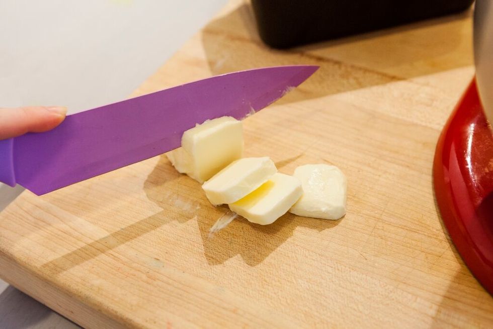 Add softened butter to bowl.