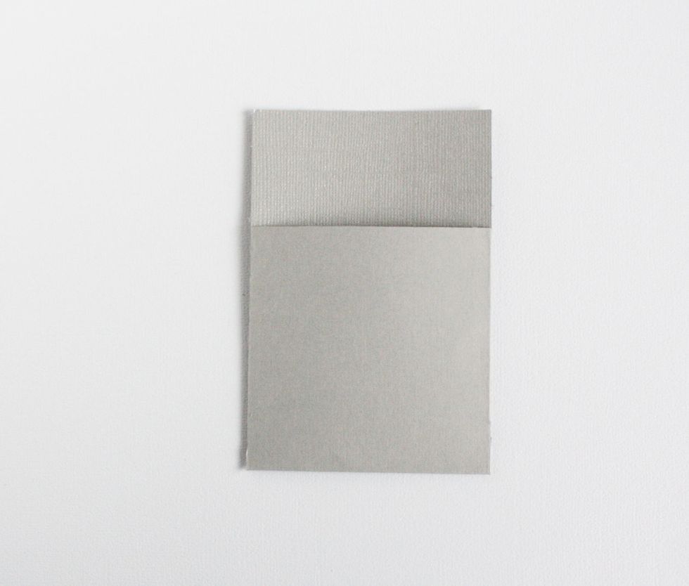 Add some adhesive to only the flaps. Fold at the score line to make the pocket.