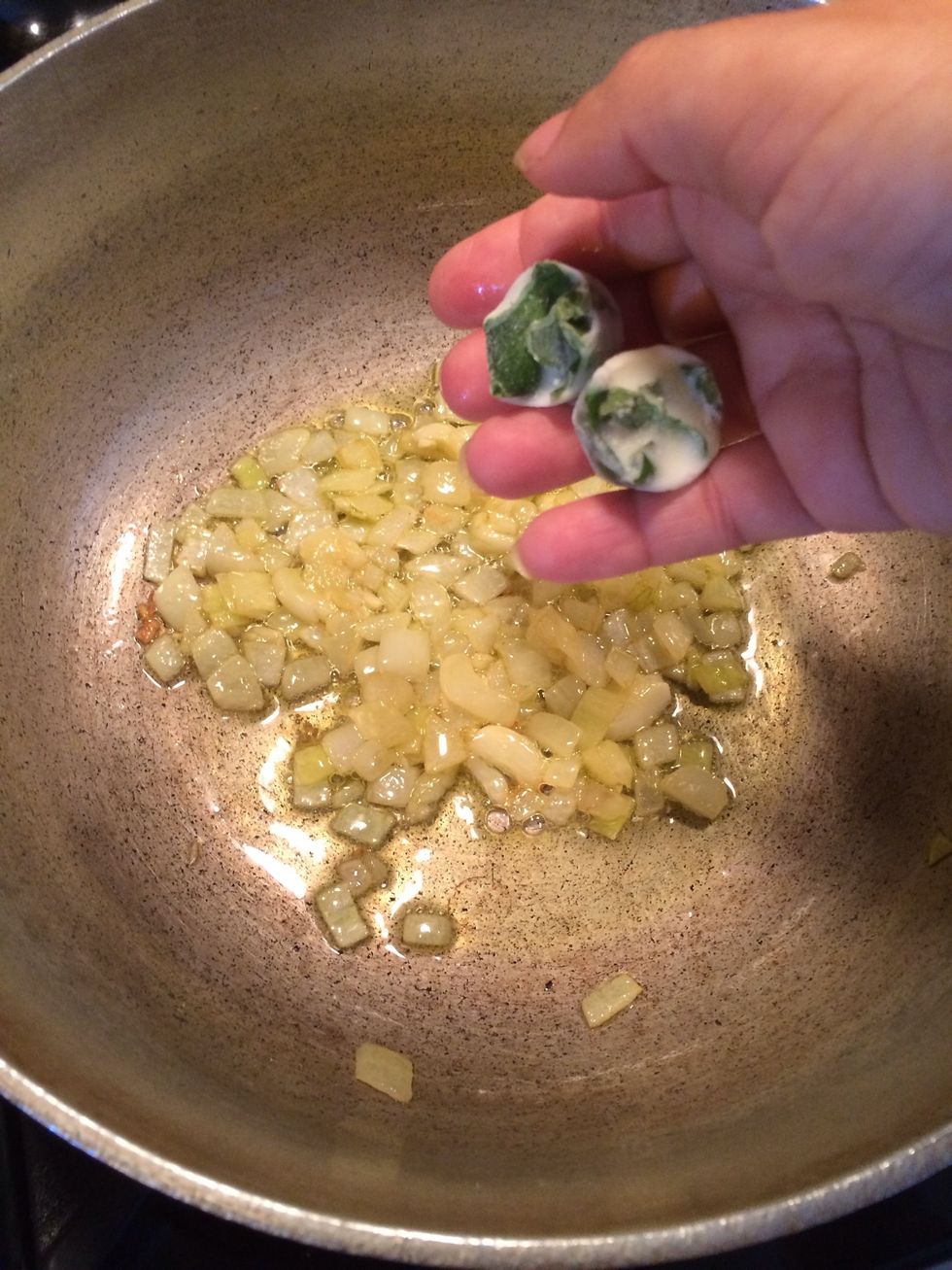 Add some basil to the oil. This will flavor it . In case you are wondering the small cube is frozen basil. See my guide on this(https://snapguide.com/guides/freeze-herbs/. Use fresh at this point