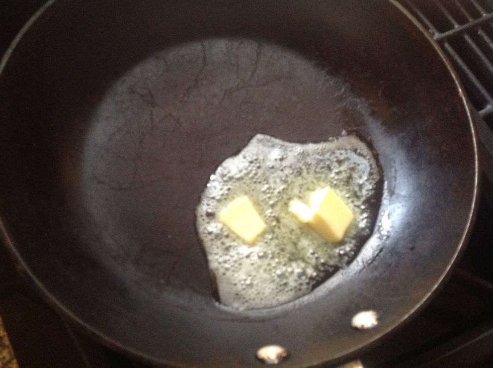 Add some butter to the frying pan set to medium temperature.